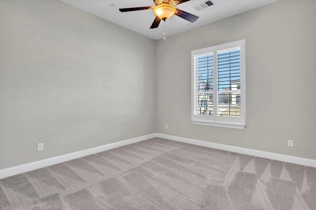 carpeted spare room with ceiling fan