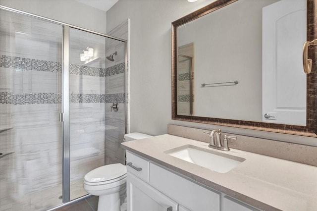 bathroom featuring toilet, vanity, and walk in shower