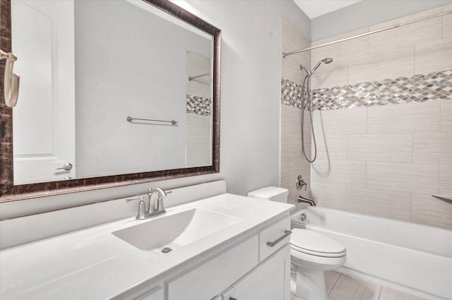 full bathroom with toilet, tile patterned flooring, vanity, and tiled shower / bath