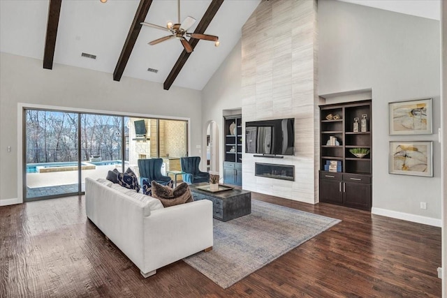 living room featuring ceiling fan, beam ceiling, a fireplace, and high vaulted ceiling