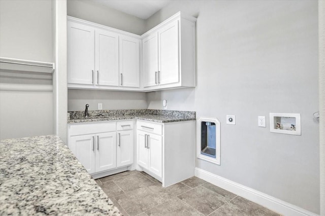 laundry room with washer hookup, electric dryer hookup, cabinets, and sink