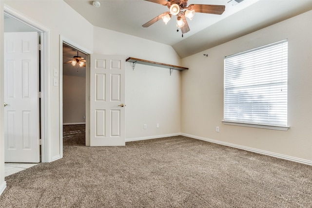 spare room featuring light carpet, a wealth of natural light, lofted ceiling, and ceiling fan