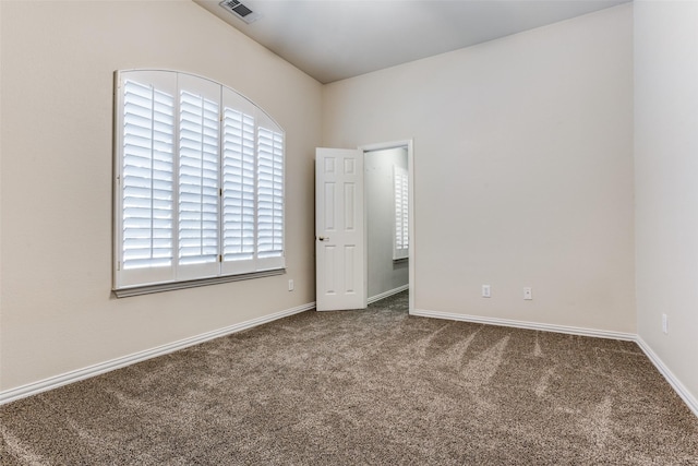 unfurnished bedroom featuring carpet and lofted ceiling