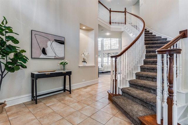 tiled entrance foyer featuring a high ceiling