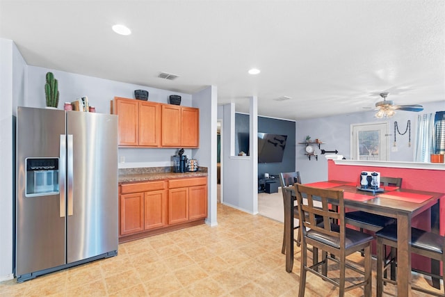 kitchen with recessed lighting, stainless steel fridge, ceiling fan, and visible vents