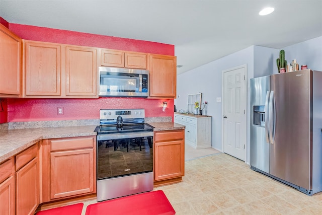 kitchen with recessed lighting, stainless steel appliances, light countertops, and light brown cabinetry