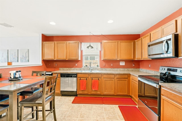 kitchen with visible vents, appliances with stainless steel finishes, light countertops, a sink, and recessed lighting