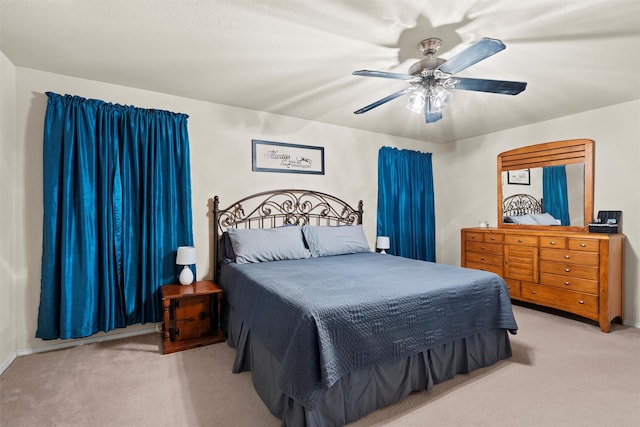 bedroom featuring ceiling fan, carpet, and baseboards