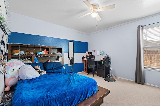 carpeted bedroom with multiple windows, baseboards, and a ceiling fan