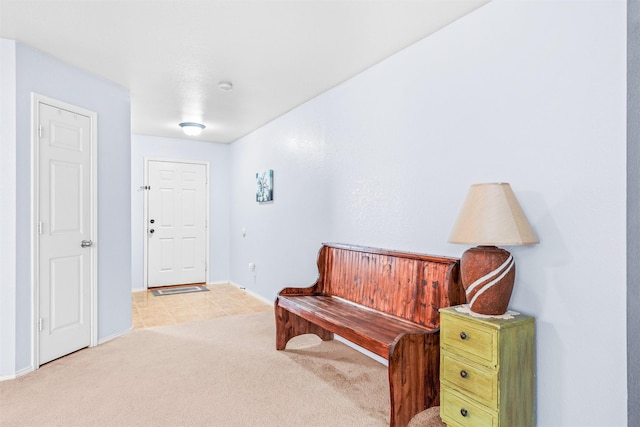 carpeted entrance foyer featuring baseboards