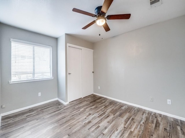 1122 Millview Dr Unit 1006, Arlington, TX 76012 - unfurnished bedroom with a closet, visible vents, baseboards, and wood finished floors