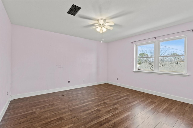 empty room featuring dark wood-type flooring and ceiling fan