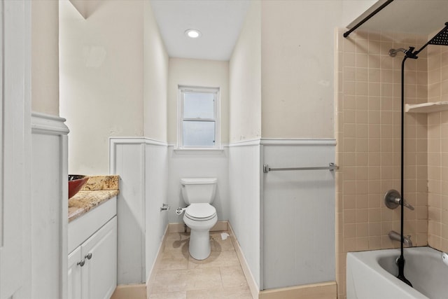 full bathroom with vanity, tiled shower / bath combo, and toilet