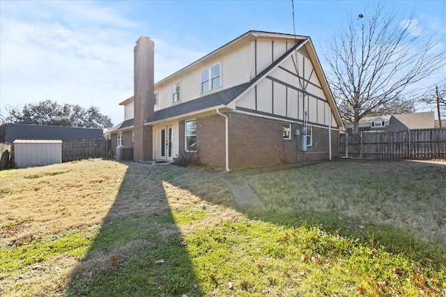 back of house with cooling unit and a yard