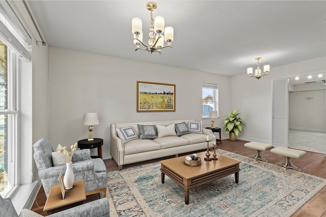 living room with hardwood / wood-style flooring and a notable chandelier