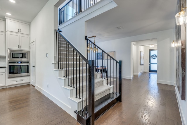 stairway featuring hardwood / wood-style floors