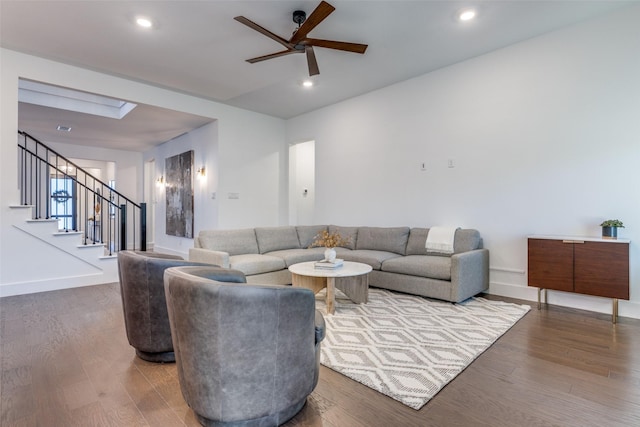 living room featuring hardwood / wood-style flooring and ceiling fan