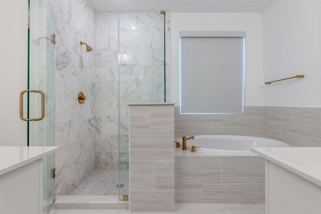 bathroom featuring vanity and separate shower and tub