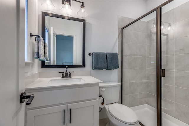 bathroom with vanity, toilet, and walk in shower