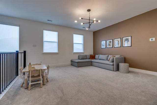 living room with light colored carpet and an inviting chandelier