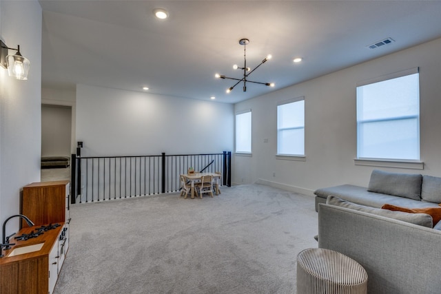 sitting room featuring an inviting chandelier and light colored carpet