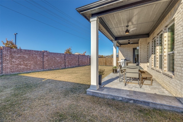 view of yard featuring ceiling fan and a patio area