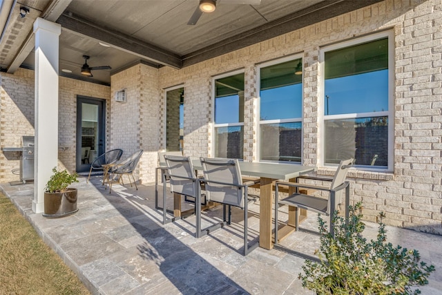 view of patio featuring area for grilling and ceiling fan