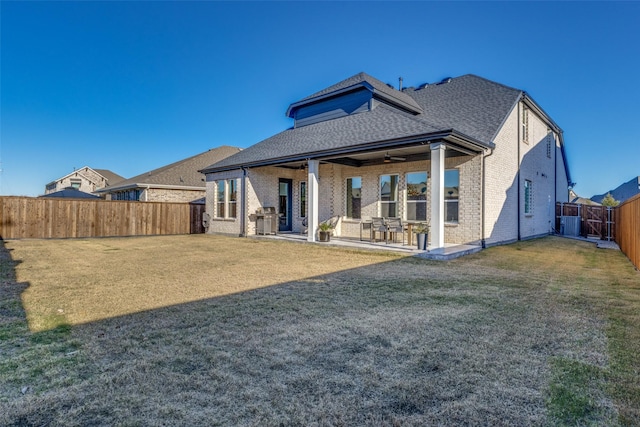 rear view of house with a yard, central AC, ceiling fan, and a patio area