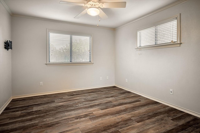 empty room featuring dark wood-style floors, crown molding, baseboards, and ceiling fan