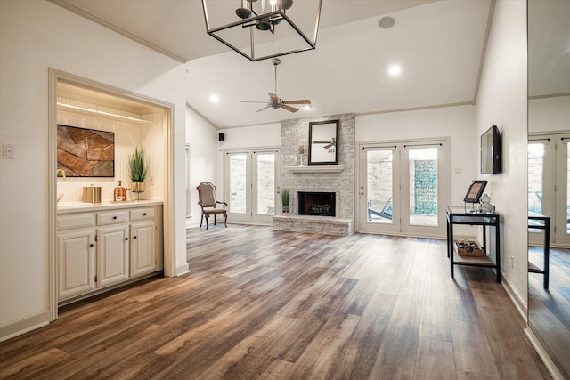 living room with hardwood / wood-style flooring, ceiling fan, a wealth of natural light, and french doors