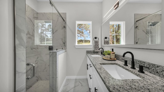 bathroom with vanity and a shower with door