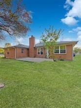 rear view of property with a yard