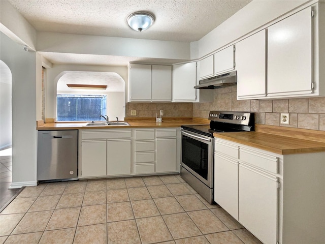 kitchen with white cabinets, a textured ceiling, stainless steel appliances, and sink