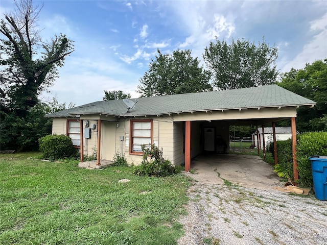 ranch-style home featuring a front yard and a carport