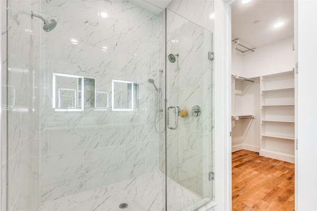 bathroom featuring hardwood / wood-style flooring and a shower with shower door