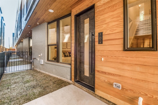 doorway to property featuring brick siding