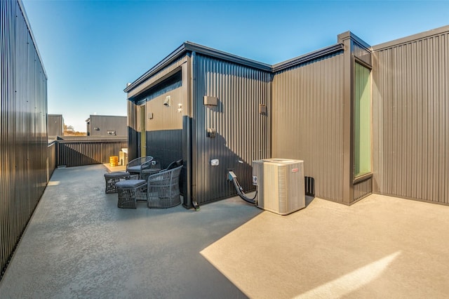 exterior space featuring outdoor dining area and central air condition unit