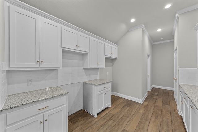 kitchen featuring crown molding, dark hardwood / wood-style flooring, white cabinets, and light stone counters