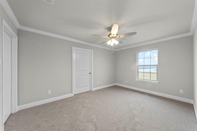 spare room with ceiling fan, ornamental molding, and carpet floors