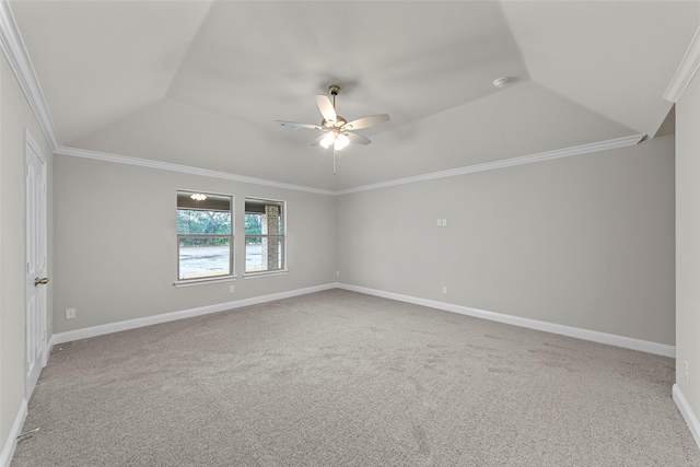 carpeted empty room featuring ceiling fan, ornamental molding, and a tray ceiling