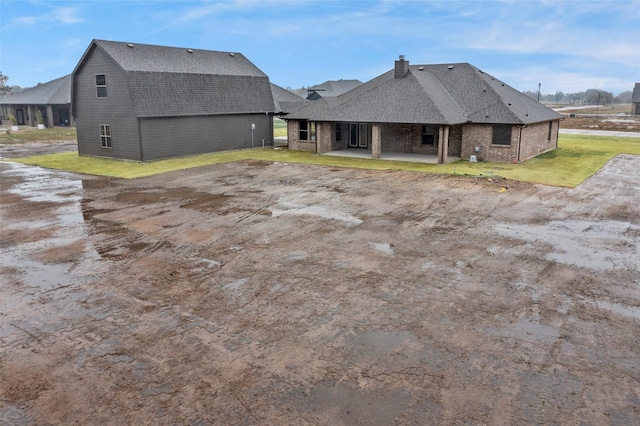 rear view of property featuring a yard