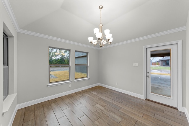 unfurnished dining area featuring a notable chandelier, light wood-type flooring, and ornamental molding