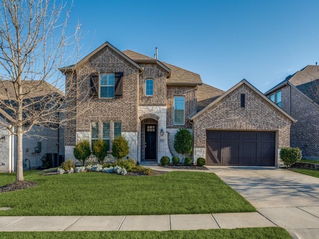 view of front of property with a garage and a front lawn