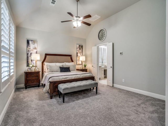 carpeted bedroom with multiple windows, ceiling fan, ensuite bathroom, and lofted ceiling