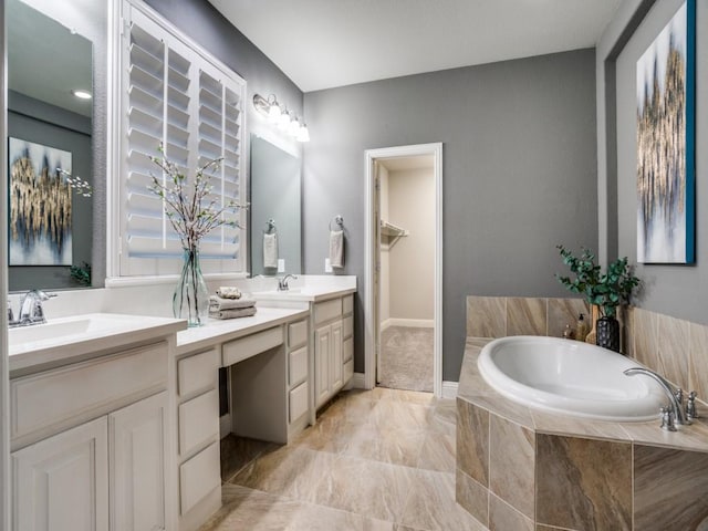 bathroom with vanity and a relaxing tiled tub