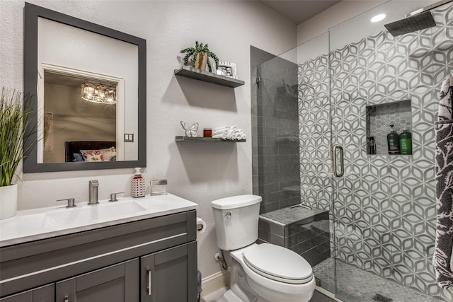 bathroom with vanity, toilet, and walk in shower