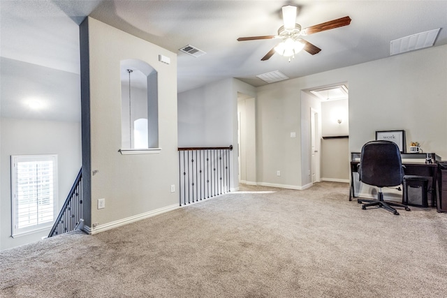 carpeted home office with ceiling fan and lofted ceiling