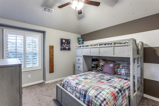 carpeted bedroom featuring vaulted ceiling and ceiling fan