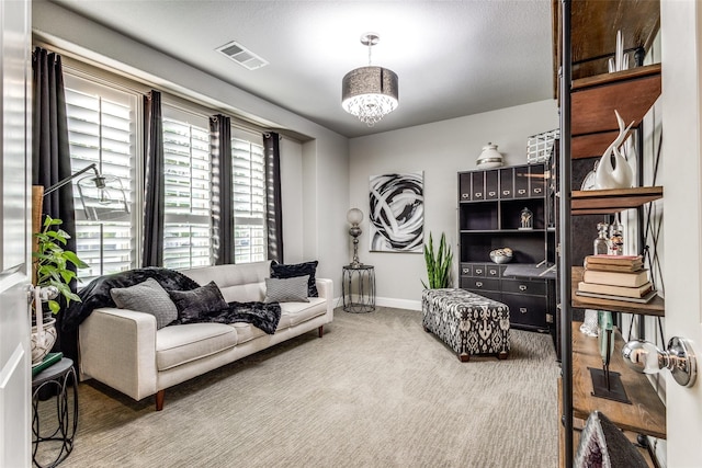 living room with carpet flooring and a chandelier