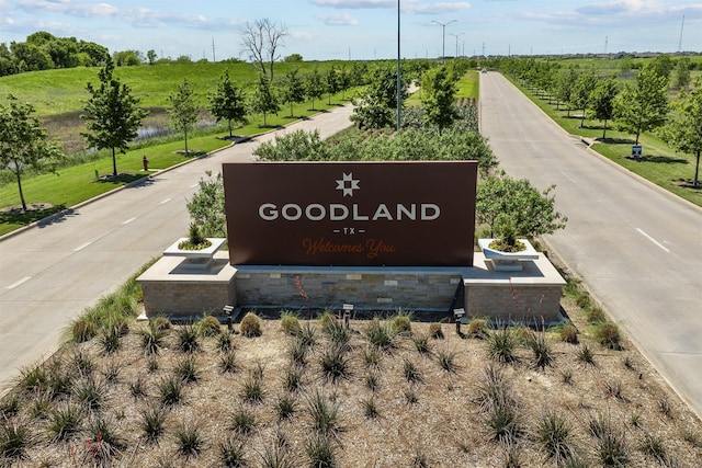 community / neighborhood sign with a rural view